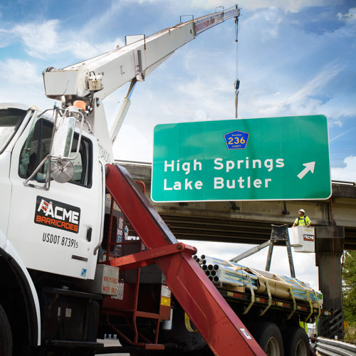 Acme Barricades installing a highway overpass permanent sign