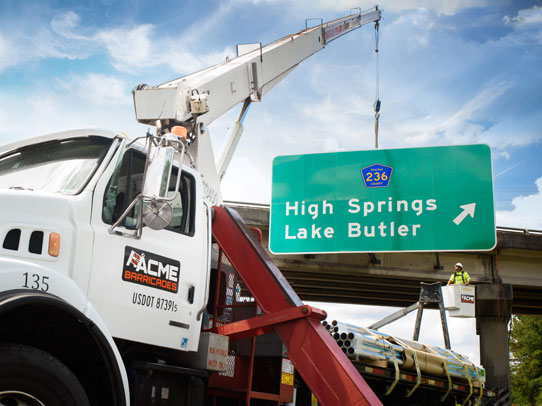 Acme Barricades installing a highway overpass permanent sign